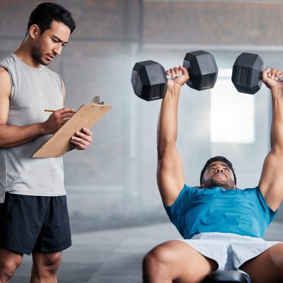 Fitness, body builder and weight, coach or personal trainer with checklist, exercise or training in.